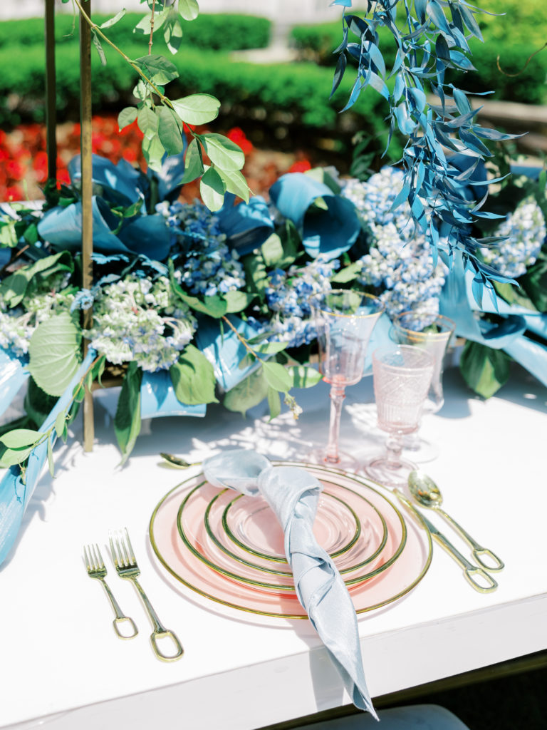 blue, pink, and gold table setting for wedding