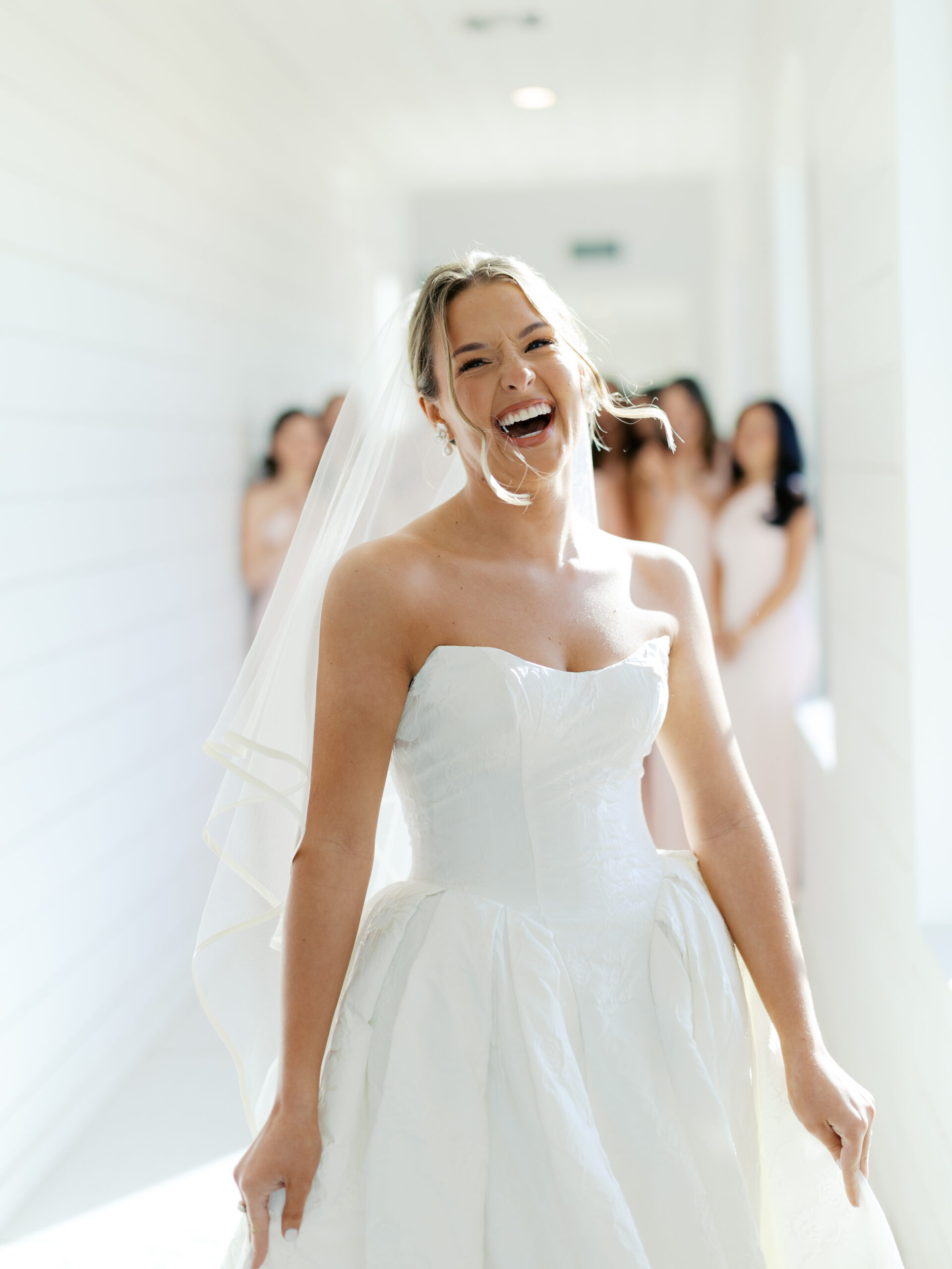 Bride smiling in front of the camera on her wedding day